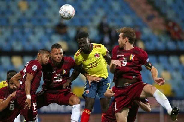Davinson Sanchez of Colombia heads the ball against Luis Martinez of Venezuela during a Group B match between Colombia and Venezuela as part of Copa...