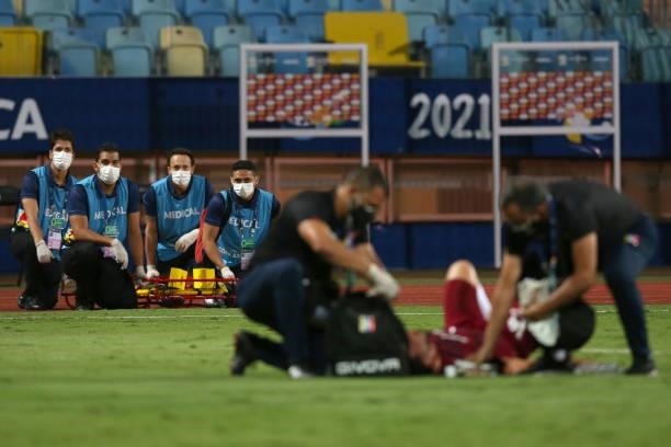 Medical staff wait with a stretcher to assist a player of Venezuela during a Group B match between Colombia and Venezuela as part of Copa America...