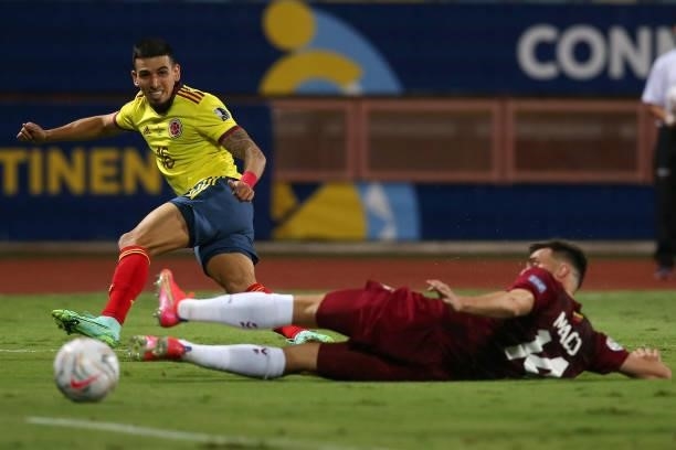 Daniel Muñoz of Colombia kicks the ball against Luis Mago of Venezuela during a Group B match between Colombia and Venezuela as part of Copa America...