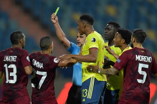 Referee Eber Aquino shows a yellow card to Yohan Cumana of Venezuela during a Group B match between Colombia and Venezuela as part of Copa America...