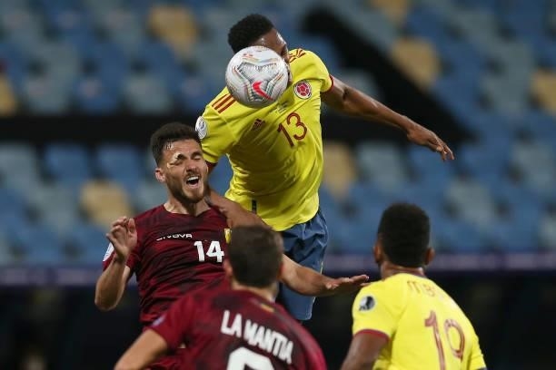 Yerry Mina of Colombia heads the ball against Luis Mago of Venezuela during a Group B match between Colombia and Venezuela as part of Copa America...