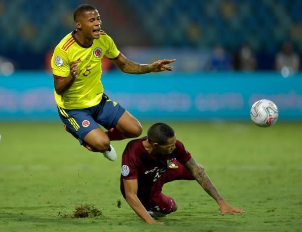 Wilmar Barrios of Colombia falls down against Yohan Cumana of Venezuela during a Group B match between Colombia and Venezuela as part of Copa America...