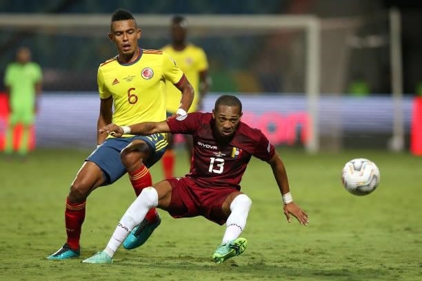 Jose Martinez of Venezuela fights for the ball with William Tesillo of Colombia during a Group B match between Colombia and Venezuela as part of Copa...