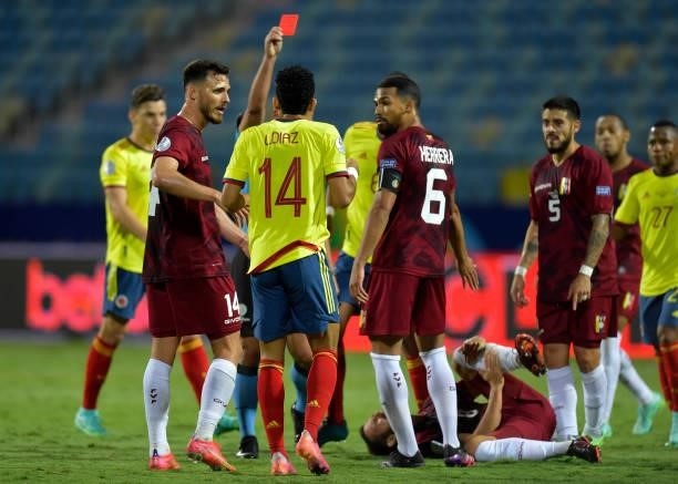 Referee Eber Aquino shows a red card to Luis Diaz of Colombia during a Group B match between Colombia and Venezuela as part of Copa America Brazil...