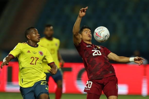 Ronald Hernandez of Venezuela chests the ball against Leandro Campaz of Colombia during a Group B match between Colombia and Venezuela as part of...