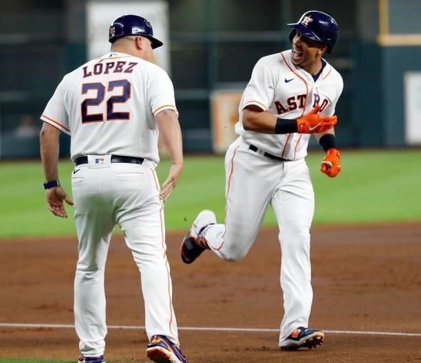 Michael Brantley of the Houston Astros is congratulated by Omar Lopez after hitting a three-run home run in the first inning against the Chicago...