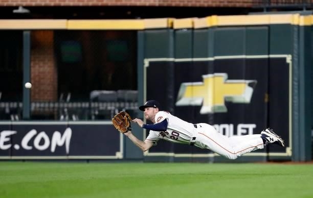 Chas McCormick of the Houston Astros makes a diving catch on a line drive off the bat of Danny Mendick of the Chicago White Sox in the third inning...