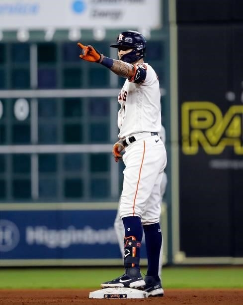 Carlos Correa of the Houston Astros gestures after his ground-rule double that scored Yuli Gurriel in the fourth inning against the Chicago White Sox...