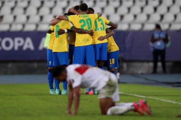 Everton Ribeiro of Brazil celebrates with teammates after scoring the third goal of his team during a match between Brazil and Peru as part of Group...
