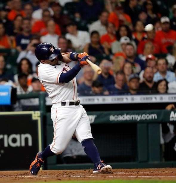 Jose Altuve of the Houston Astros hits a sacrifice fly in the fourth inning against the Chicago White Sox at Minute Maid Park on June 17, 2021 in...