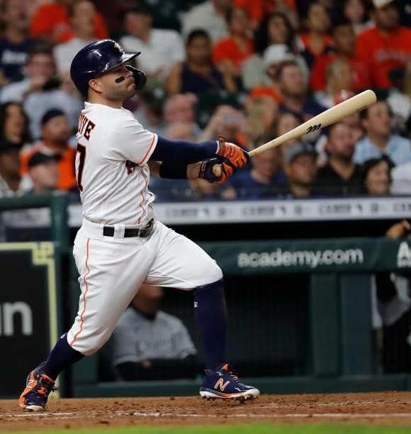 Jose Altuve of the Houston Astros hits a sacrifice fly in the fourth inning against the Chicago White Sox at Minute Maid Park on June 17, 2021 in...
