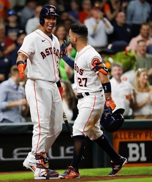 Jose Altuve of the Houston Astros is congratulated by Michael Brantley after hitting a solo home run in the sixth inning against the Chicago White...