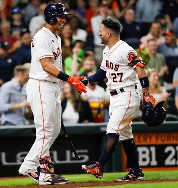 Jose Altuve of the Houston Astros is congratulated by Michael Brantley after hitting a solo home run in the sixth inning against the Chicago White...