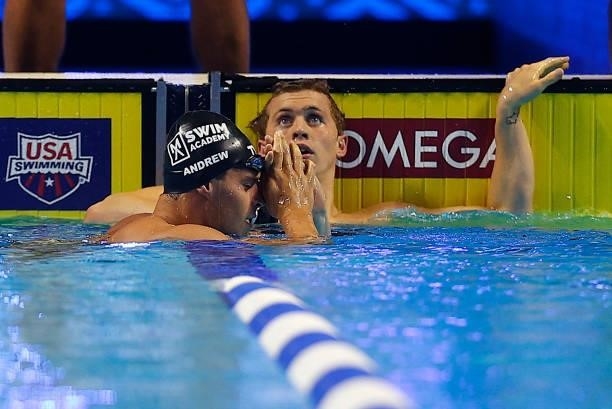 Michael Andrew and Carson Foster of the United States react after competing in a semifinal heat for the Men's 200m individual medley during Day Five...