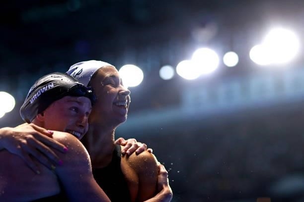 Erika Brown and Catie Deloof of the United States react after competing in a semifinal heat for the Women's 100m freestyle during Day Five of the...