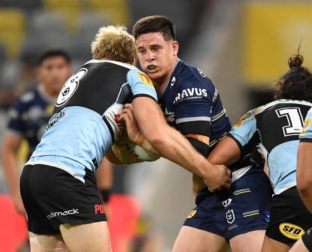 Shane Wright of the Cowboys is tackled by Aiden Tolman of the Sharks during the round 15 NRL match between the North Queensland Cowboys and the...