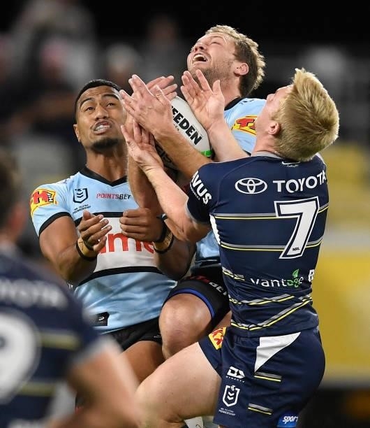 Matt Moylan of the Sharks contests the ball with Tom Dearden of the Cowboys during the round 15 NRL match between the North Queensland Cowboys and...