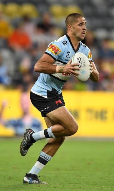 William Kennedy of the Sharks runs the ball during the round 15 NRL match between the North Queensland Cowboys and the Cronulla Sharks at QCB...