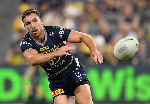 Reece Robson of the Cowboys passes the ball during the round 15 NRL match between the North Queensland Cowboys and the Cronulla Sharks at QCB...