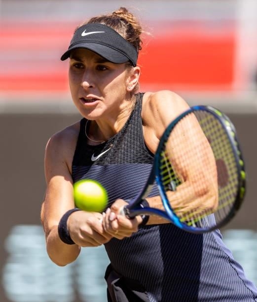 Belinda Bencic of Switzerland hits a backhand against Ekaterina Alexandrova of Russia in the women's singles quarter final match during day 7 of the...