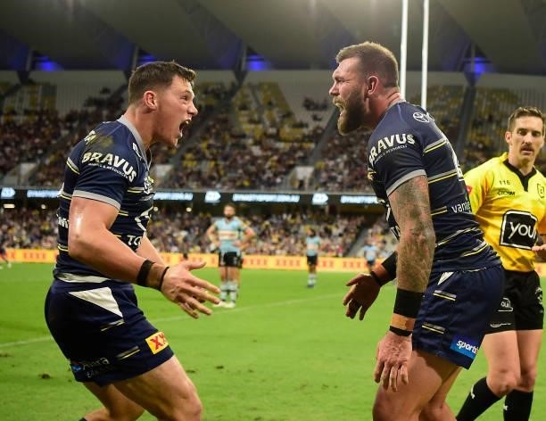 Kyle Feldt celebrates with and Scott Drinkwater of the Cowboys after scoring a try during the round 15 NRL match between the North Queensland Cowboys...