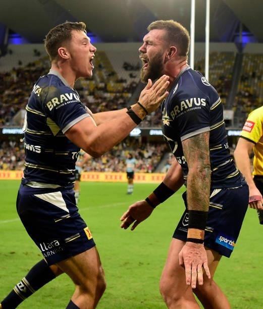 Kyle Feldt celebrates with and Scott Drinkwater of the Cowboys after scoring a try during the round 15 NRL match between the North Queensland Cowboys...