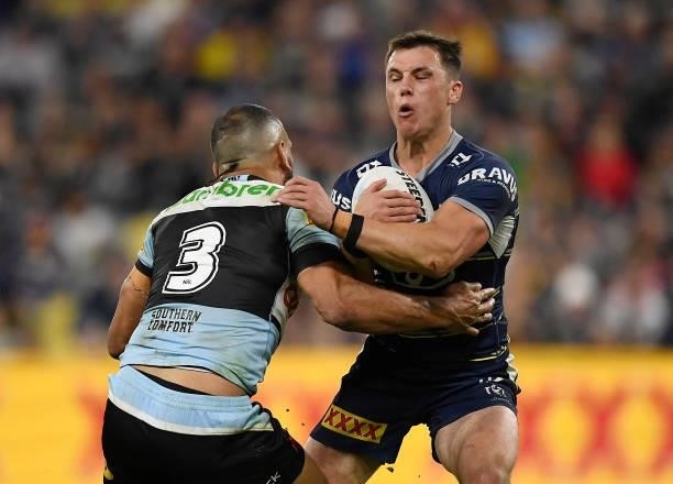 Scott Drinkwater of the Cowboys is tackled by Will Chambers of the Sharks during the round 15 NRL match between the North Queensland Cowboys and the...