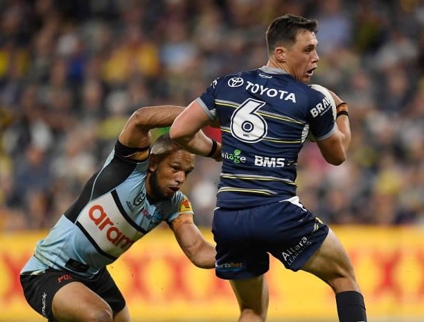 Scott Drinkwater of the Cowboys is tackled by Will Chambers of the Sharks during the round 15 NRL match between the North Queensland Cowboys and the...