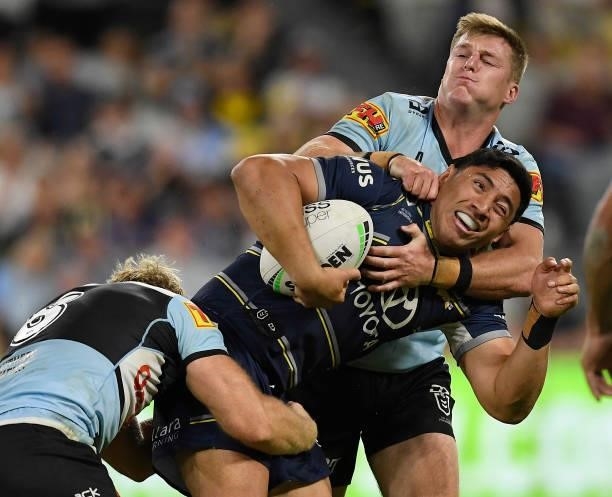 Jason Taumalolo of the Cowboys is tackled during the round 15 NRL match between the North Queensland Cowboys and the Cronulla Sharks at QCB Stadium,...