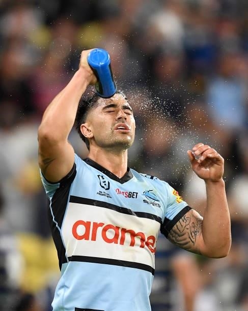 Shaun Johnson of the Sharks spays his face with water during the round 15 NRL match between the North Queensland Cowboys and the Cronulla Sharks at...