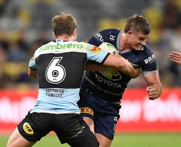 Mitch Dunn of the Cowboys is tackled by Matt Moylan of the Sharks during the round 15 NRL match between the North Queensland Cowboys and the Cronulla...
