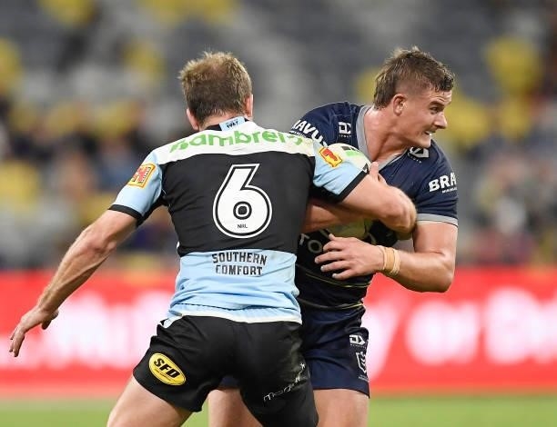 Mitch Dunn of the Cowboys is tackled by Matt Moylan of the Sharks during the round 15 NRL match between the North Queensland Cowboys and the Cronulla...