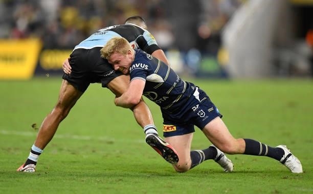 Tom Dearden of the Cowboys tackles Will Chambers of the Sharks during the round 15 NRL match between the North Queensland Cowboys and the Cronulla...
