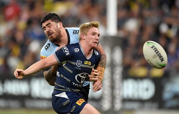 Tom Dearden of the Cowboys is tackled by Braden Hamlin-Uele of the Sharks during the round 15 NRL match between the North Queensland Cowboys and the...