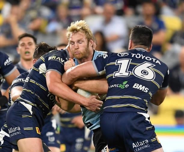 Aiden Tolman of the Sharks is tackled during the round 15 NRL match between the North Queensland Cowboys and the Cronulla Sharks at QCB Stadium, on...