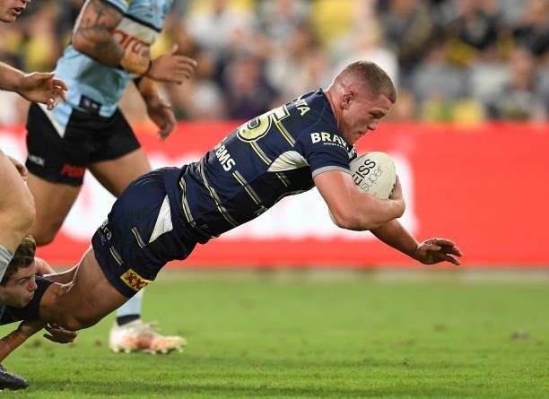 Tom Gilbert of the Cowboys is tackled during the round 15 NRL match between the North Queensland Cowboys and the Cronulla Sharks at QCB Stadium, on...
