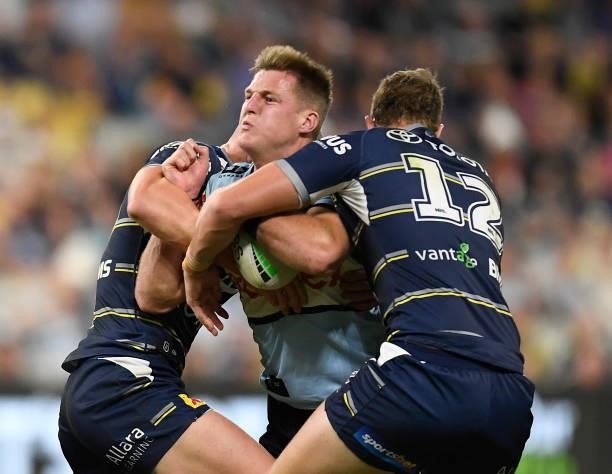 Teig Wilton of the Sharks is tackled during the round 15 NRL match between the North Queensland Cowboys and the Cronulla Sharks at QCB Stadium, on...
