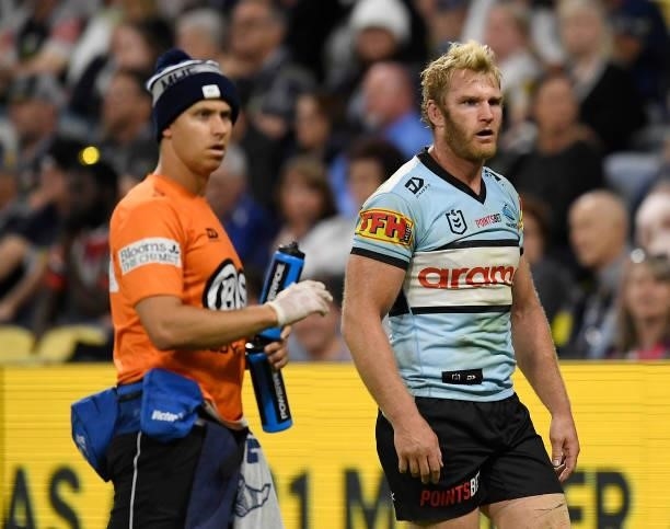 Aiden Tolman of the Sharks walks from the field after being injured during the round 15 NRL match between the North Queensland Cowboys and the...