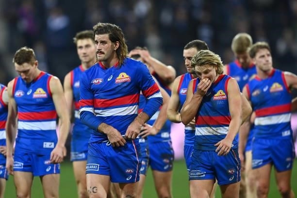 The Bulldogs look dejected after losing the round 13 AFL match between the Geelong Cats and the Western Bulldogs at GMHBA Stadium on June 18, 2021 in...