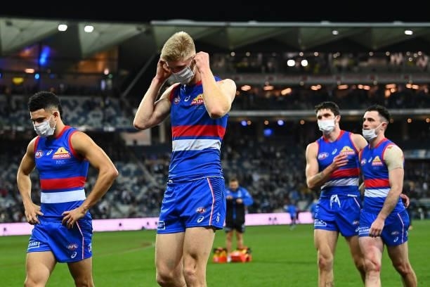 Jason Johannisen, Tim English, Bailey Williams and Toby McLean of the Bulldogs look dejected after losing the round 13 AFL match between the Geelong...