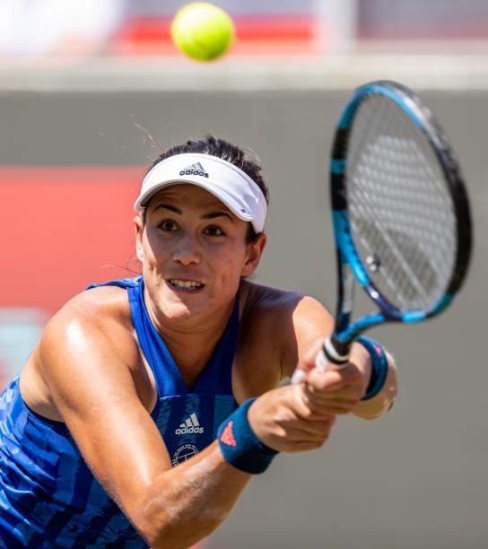 Garbine Muguruza of Spain stretches to play a backhand against Alize Cornet of France in the women's singles quarter final match during day 7 of the...