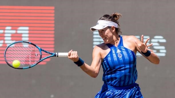 Garbine Muguruza of Spain hits a forehand against Alize Cornet of France in the women's singles quarter final match during during day 7 of the...