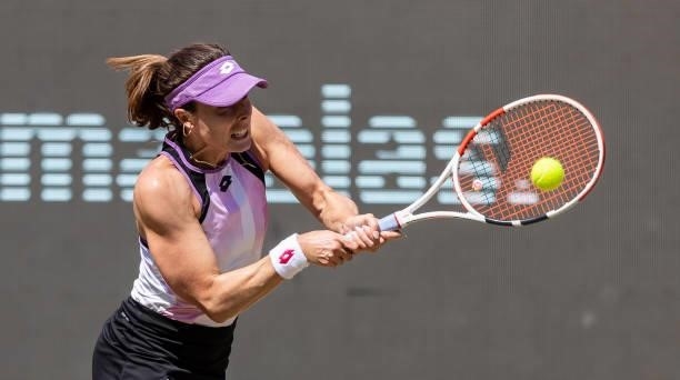 Alize Cornet of France hits a backhand against Garbine Muguruza of Spain in the women's singles quarter final match during day 7 of the bett1open at...