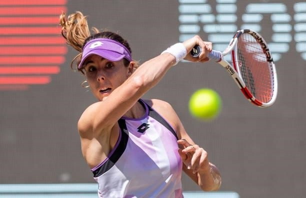 Alize Cornet of France hits a forehand against Garbine Muguruza of Spain in the women's singles quarter final match during day 7 of the bett1open at...