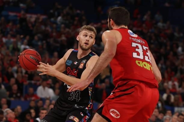 Jock Landale of Melbourne United controls the ball against John Mooney of the Wildcats during game one of the NBL Grand Final Series between the...