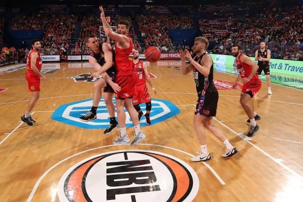 Mitch McCarron of Melbourne United dishes the ball off to Jock Landale during game one of the NBL Grand Final Series between the Perth Wildcats and...