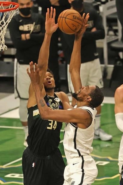 Kevin Durant of the Brooklyn Nets shoots against Giannis Antetokounmpo of the Milwaukee Bucks at Fiserv Forum on June 17, 2021 in Milwaukee,...