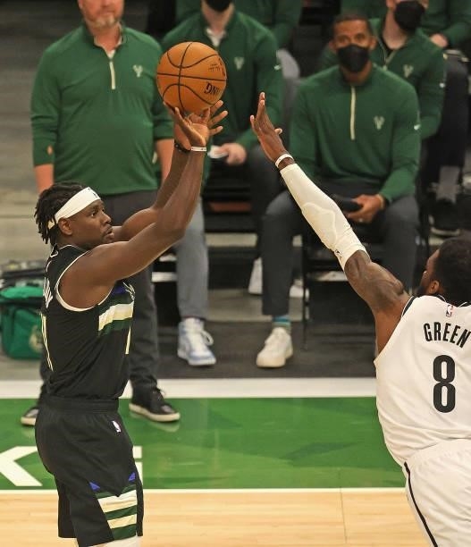 Jrue Holiday of the Milwaukee Bucks shoots against Jeff Green of the Brooklyn Nets at Fiserv Forum on June 17, 2021 in Milwaukee, Wisconsin. The...