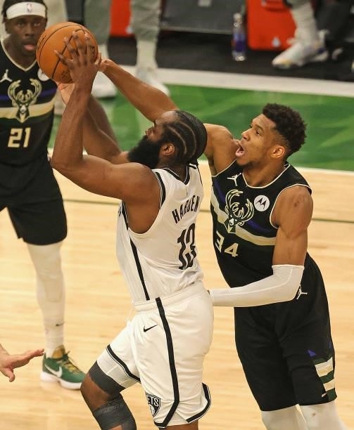 James Harden of the Brooklyn Nets shoots under pressure from Giannis Antetokounmpo of the Milwaukee Bucks at Fiserv Forum on June 17, 2021 in...