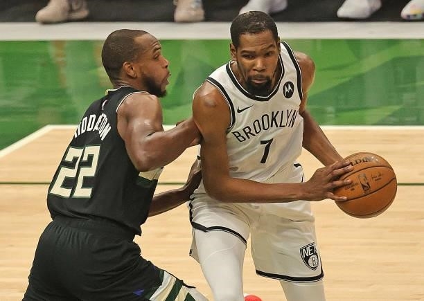 Kevin Durant of the Brooklyn Nets moves against Khris Middleton of the Milwaukee Bucks at Fiserv Forum on June 17, 2021 in Milwaukee, Wisconsin. The...